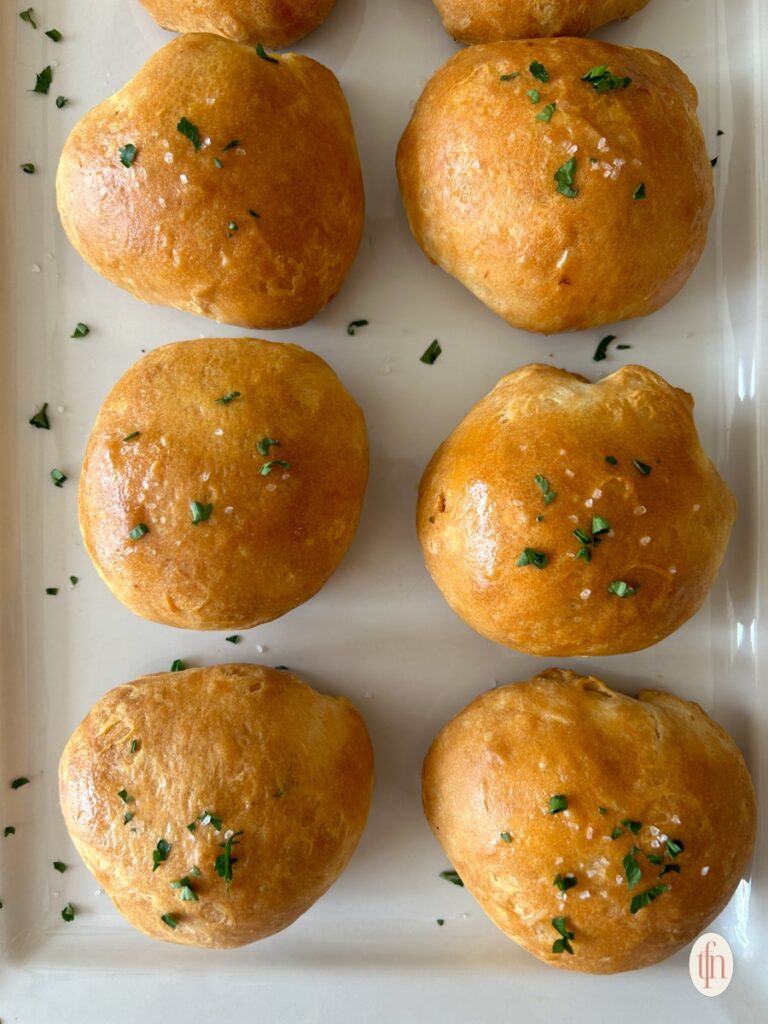 A Plate Of Buffalo Chicken Bombs Topped With Parsley.